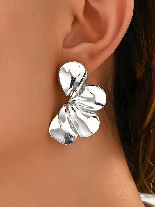 Silver butterfly-shaped earrings worn by a person