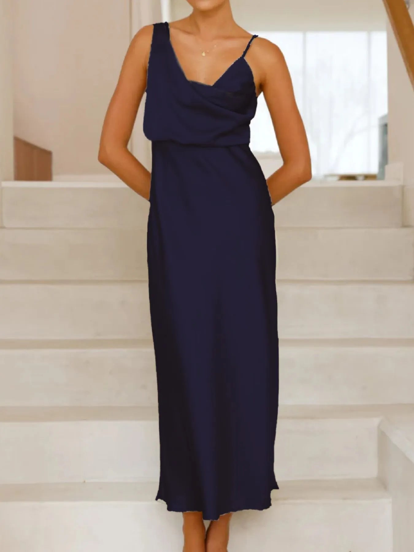 Navy blue dress worn by a person standing on white steps.