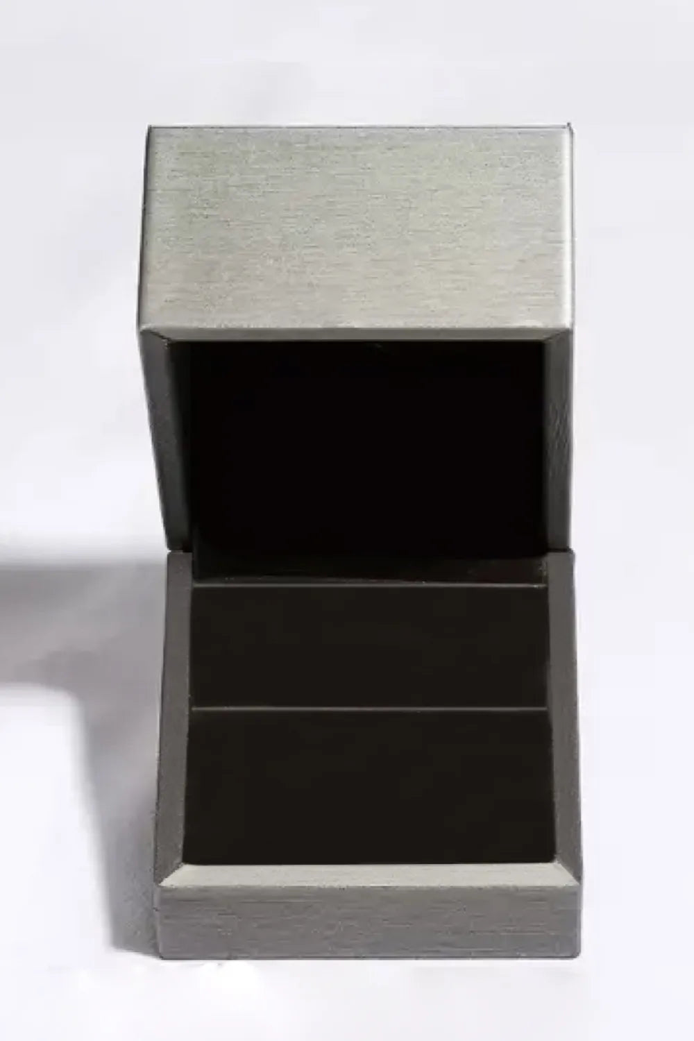 Black box with textured silver top on a white background