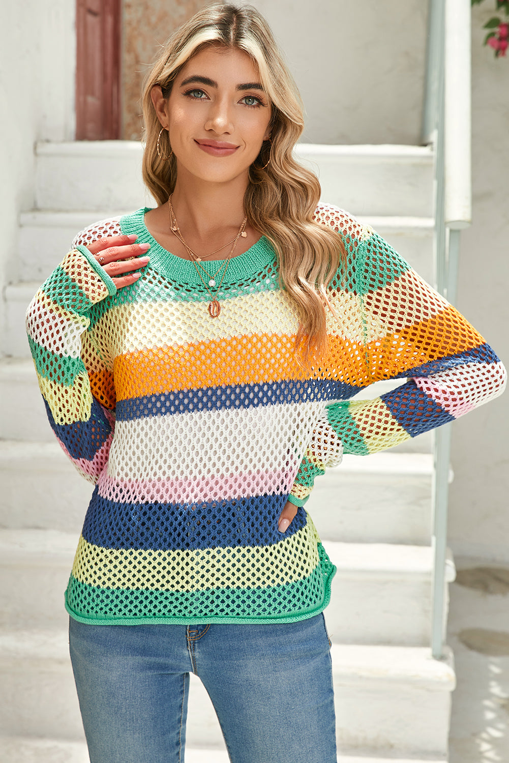 Woman wearing a colorful mesh sweater with a blurred background