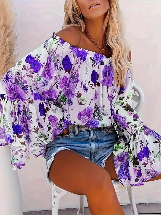 Woman wearing a floral off-shoulder top and denim shorts sitting on a chair.