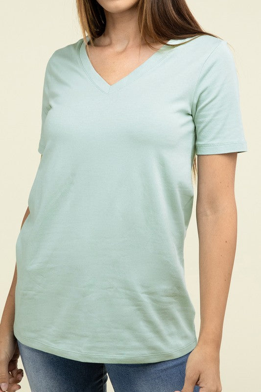 Person wearing a light green t-shirt against a beige background
