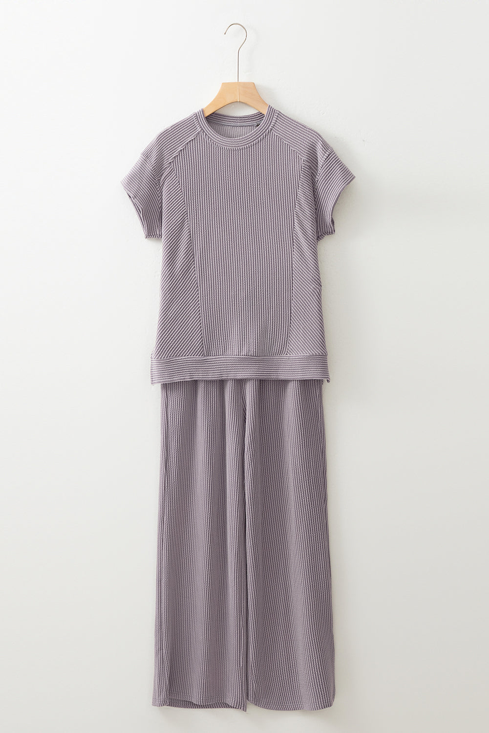 Gray ribbed dress with cap sleeves on a hanger against a white background