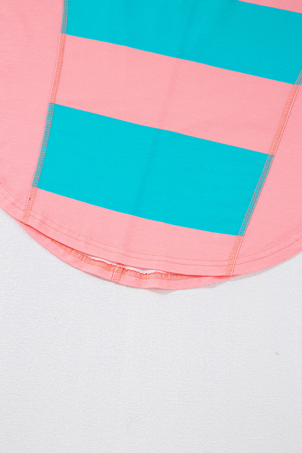 Close-up of a pink and blue striped fabric pocket on a white background