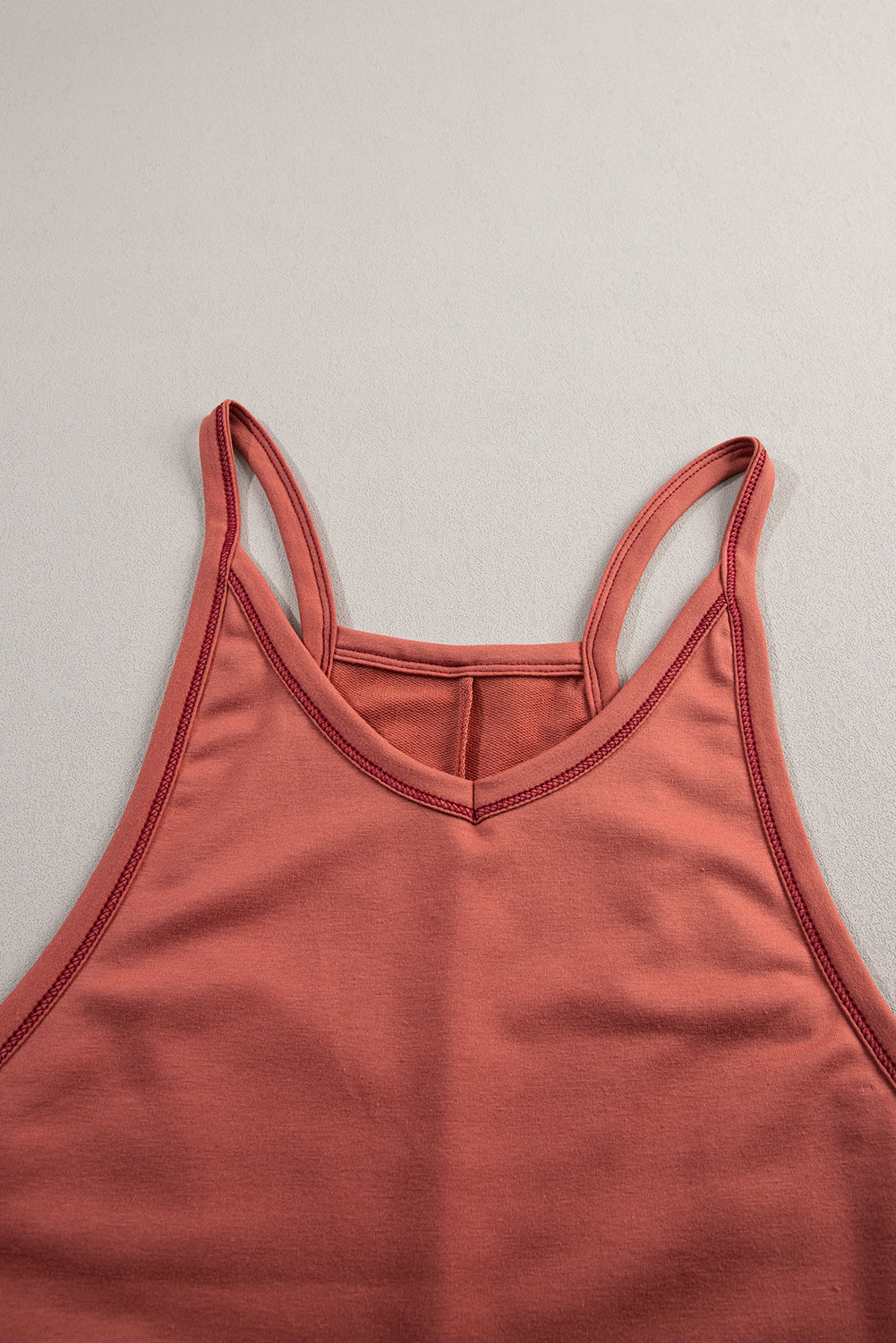 Coral tank top on a light gray background