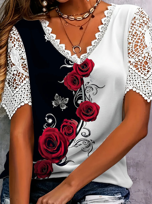 Woman wearing a black and white blouse with red roses and lace details.