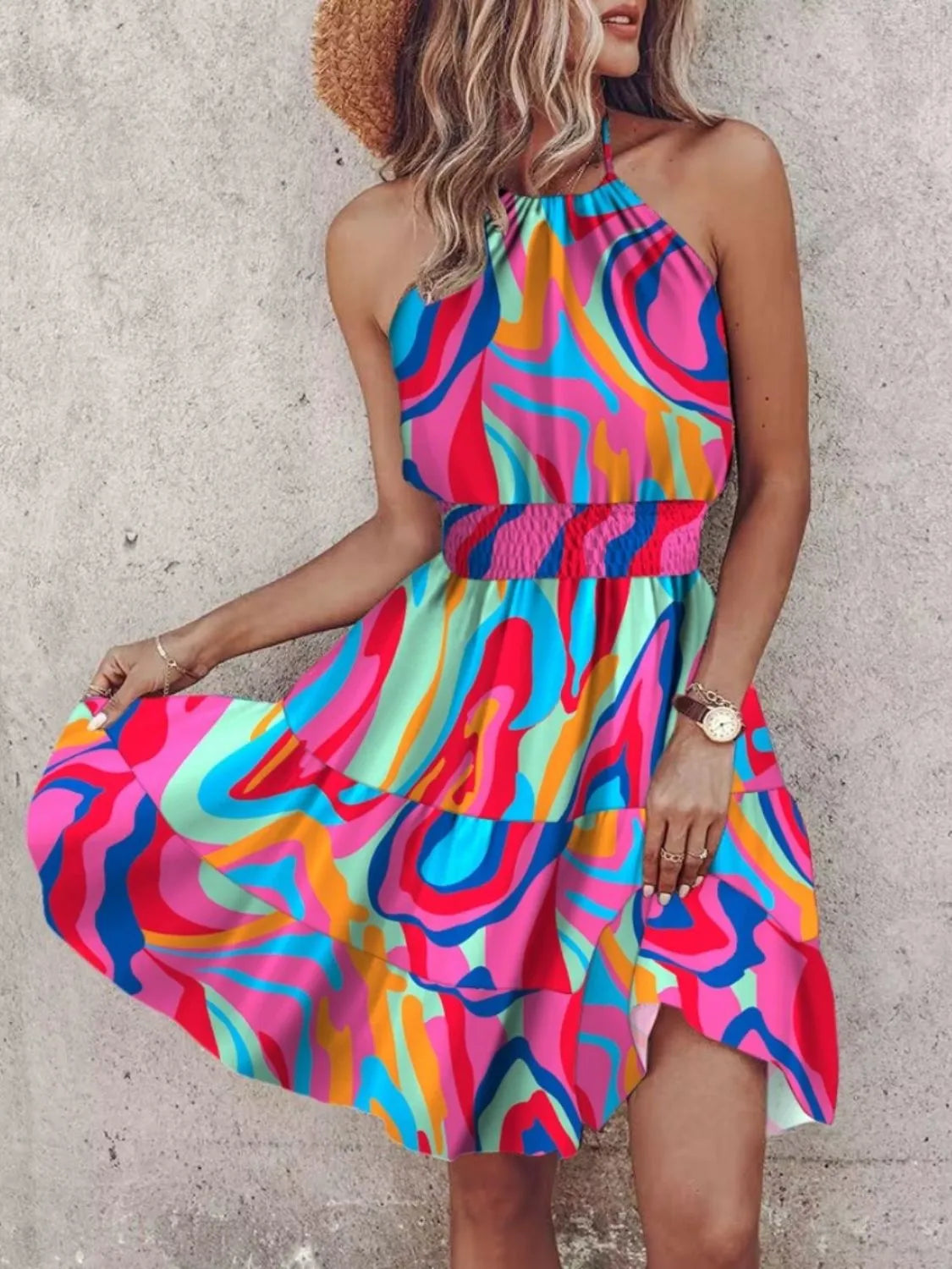 Woman wearing a colorful dress with a concrete wall background