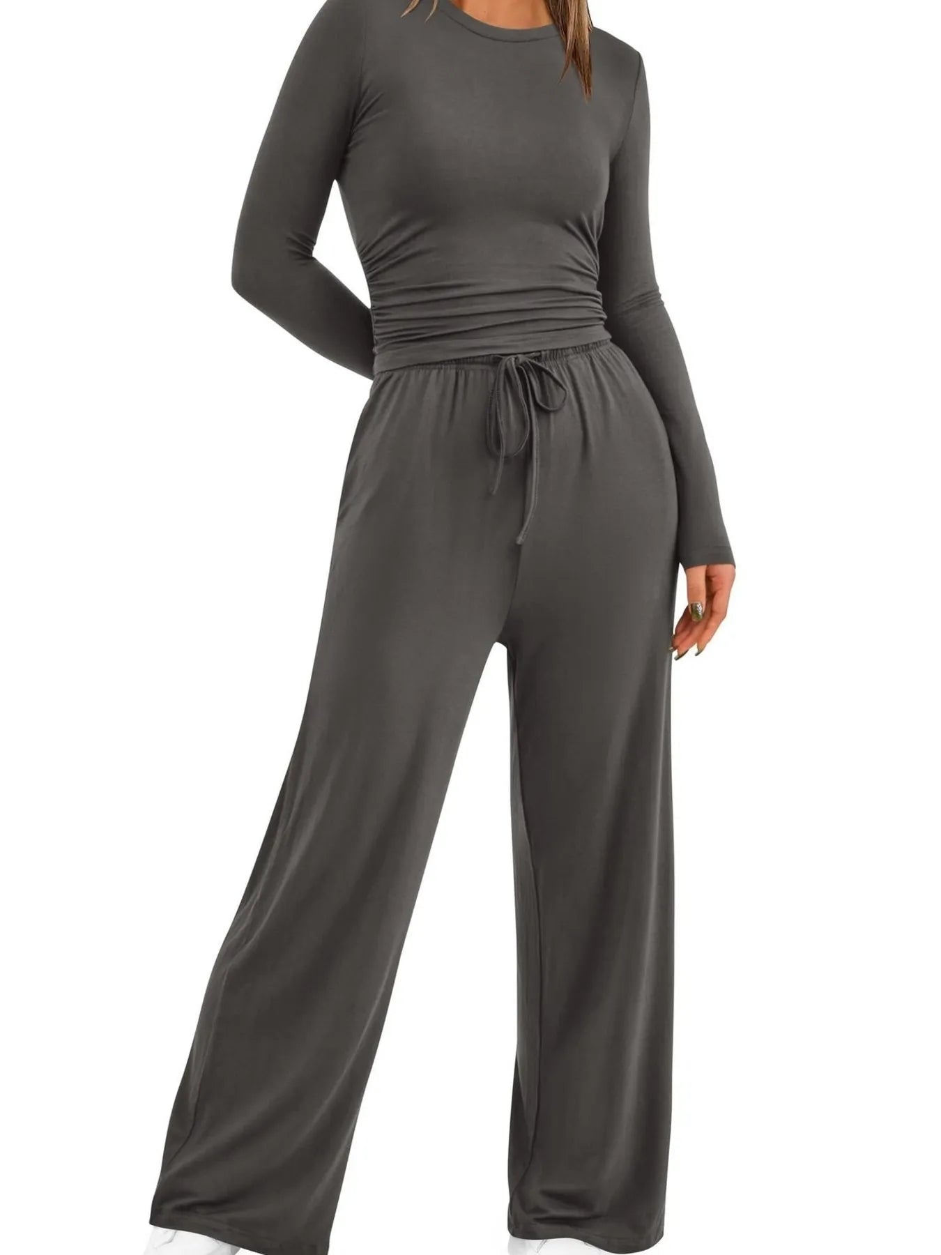 Gray jumpsuit with long sleeves and wide-leg pants on a white background