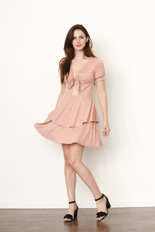 Woman wearing a pink dress with a white background
