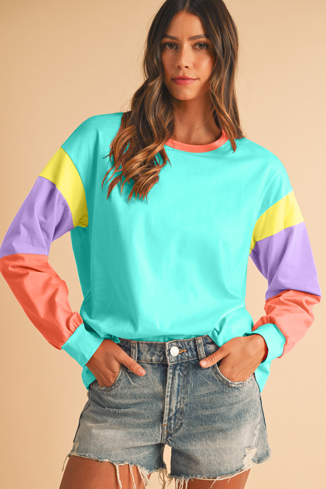 Woman wearing a colorful sweater with a beige background