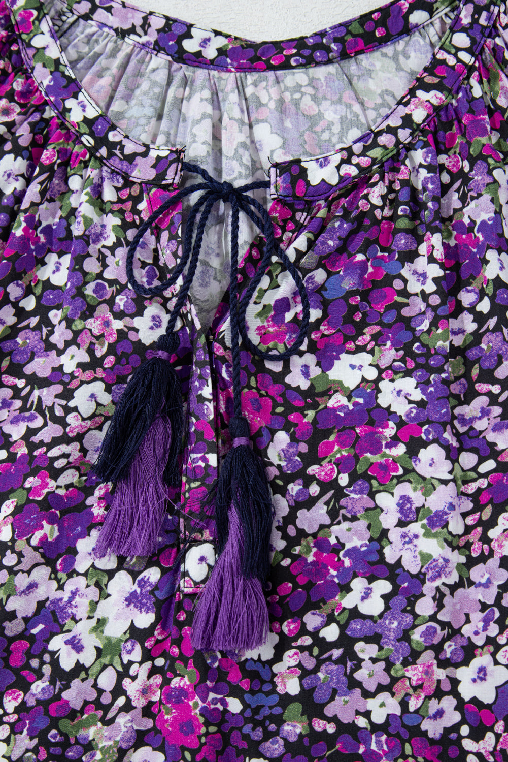 Floral dress with purple tassels on a floral background