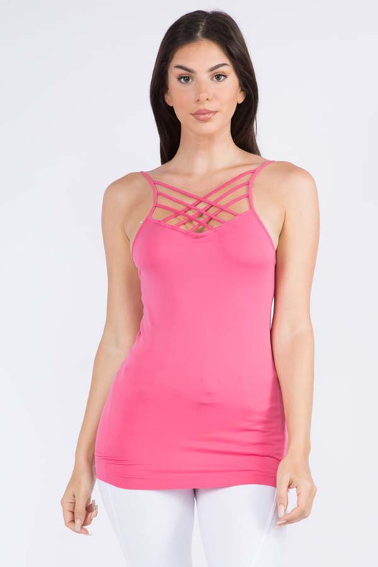 Woman wearing a pink tank top with criss-cross straps on a white background