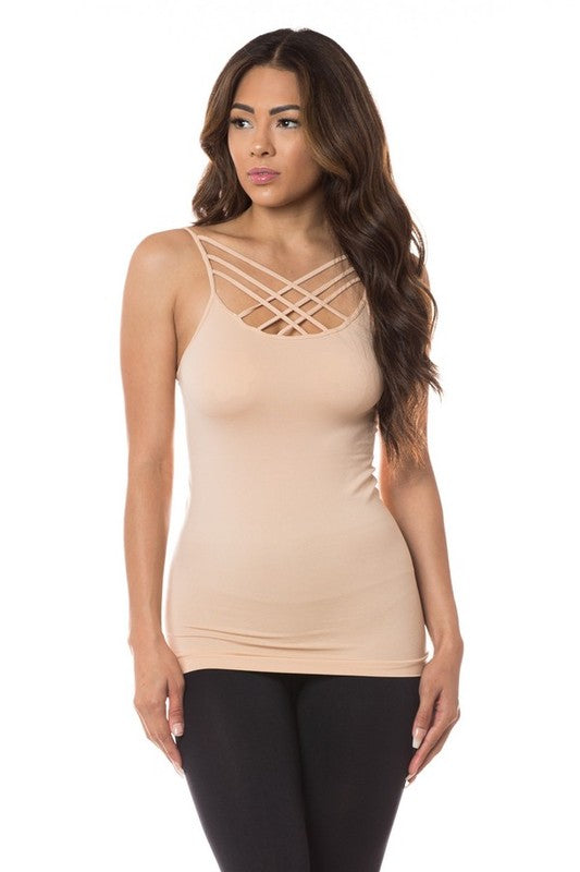 Woman wearing a beige tank top with criss-cross straps on a white background