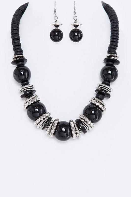 Black beaded necklace and earrings on a white background