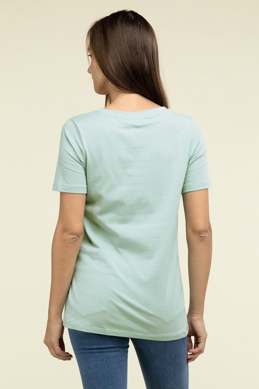 Woman wearing a light blue t-shirt on a beige background
