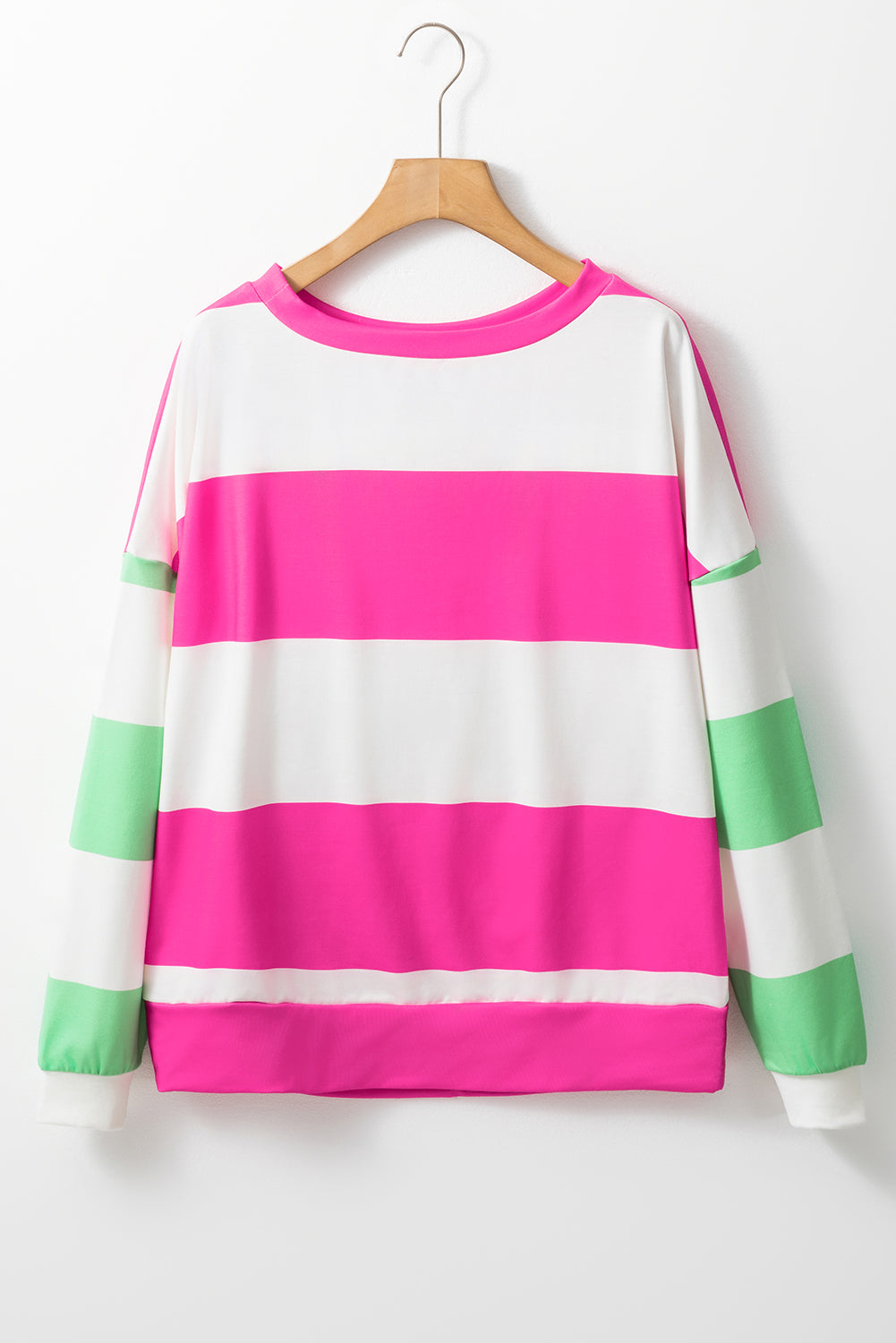 Colorful striped sweater on a hanger against a white background