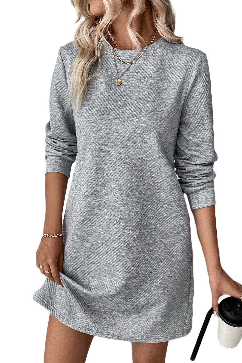 Gray long-sleeve dress worn by a person on a white background