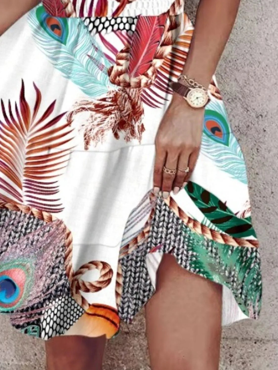 Colorful dress with peacock feather pattern worn by a person.