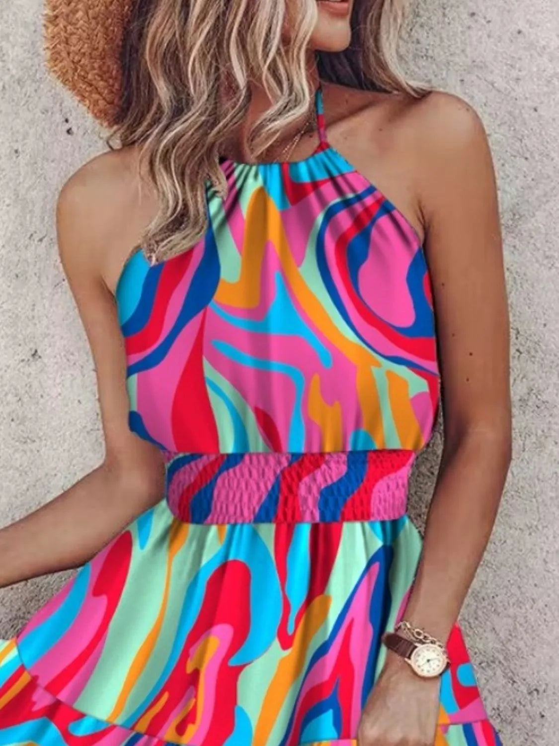 Woman wearing a colorful halter top with a blurred background