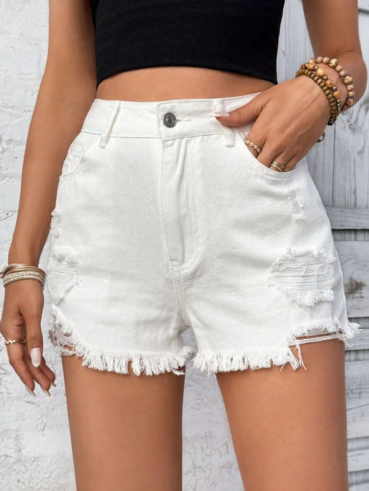 White denim shorts worn by a person against a light gray background