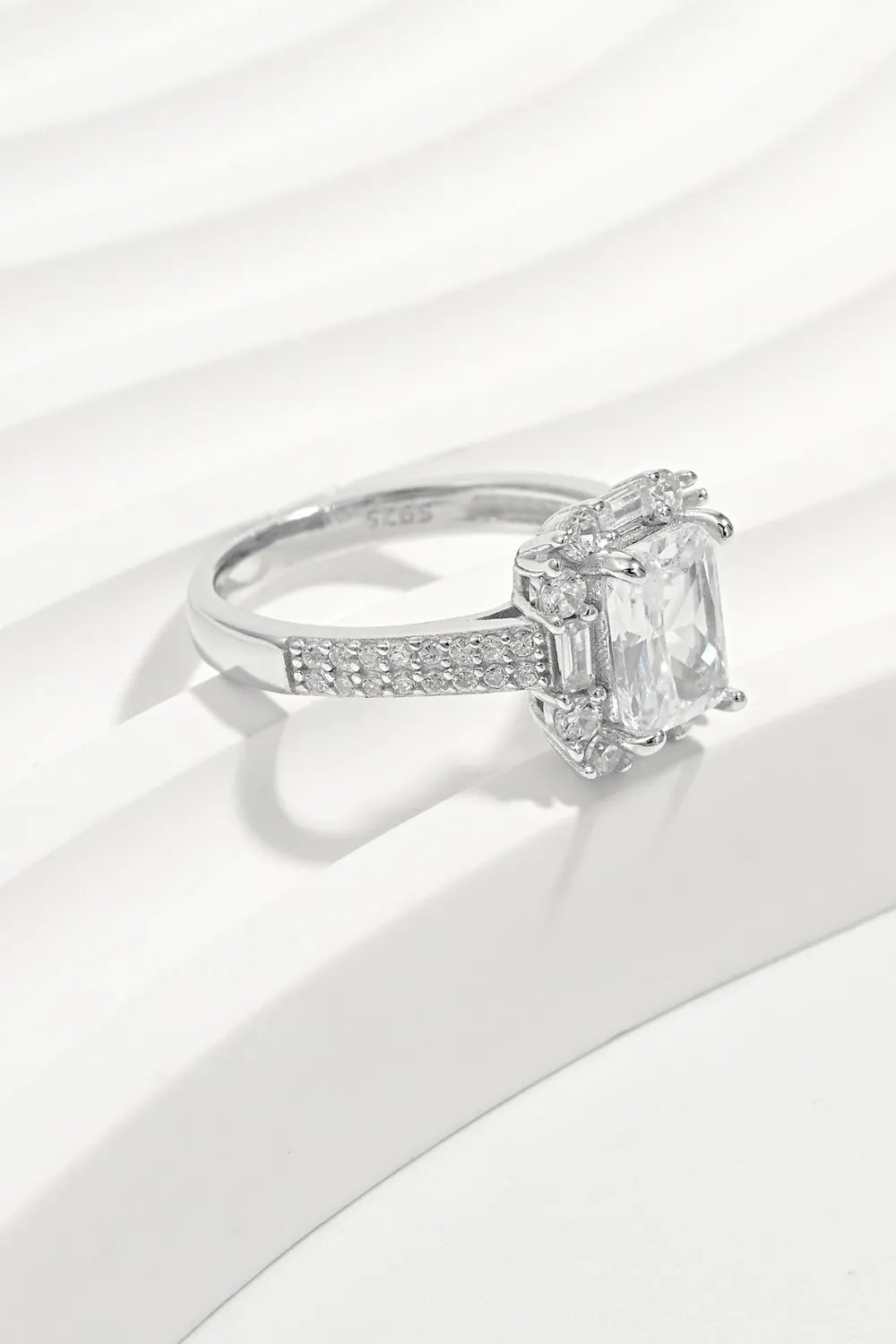 Diamond ring with a rectangular stone on a white background