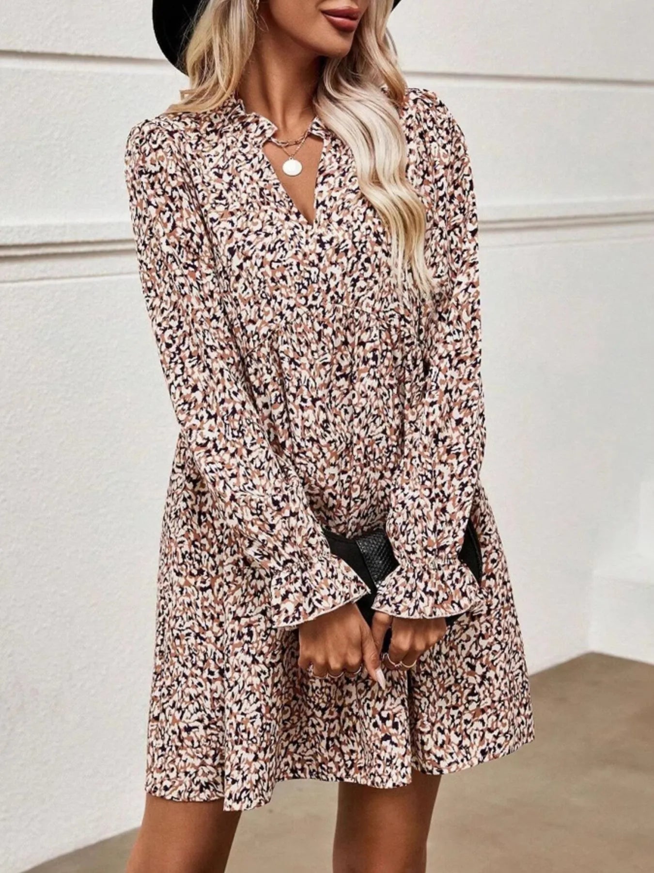 Woman wearing a floral dress against a plain background