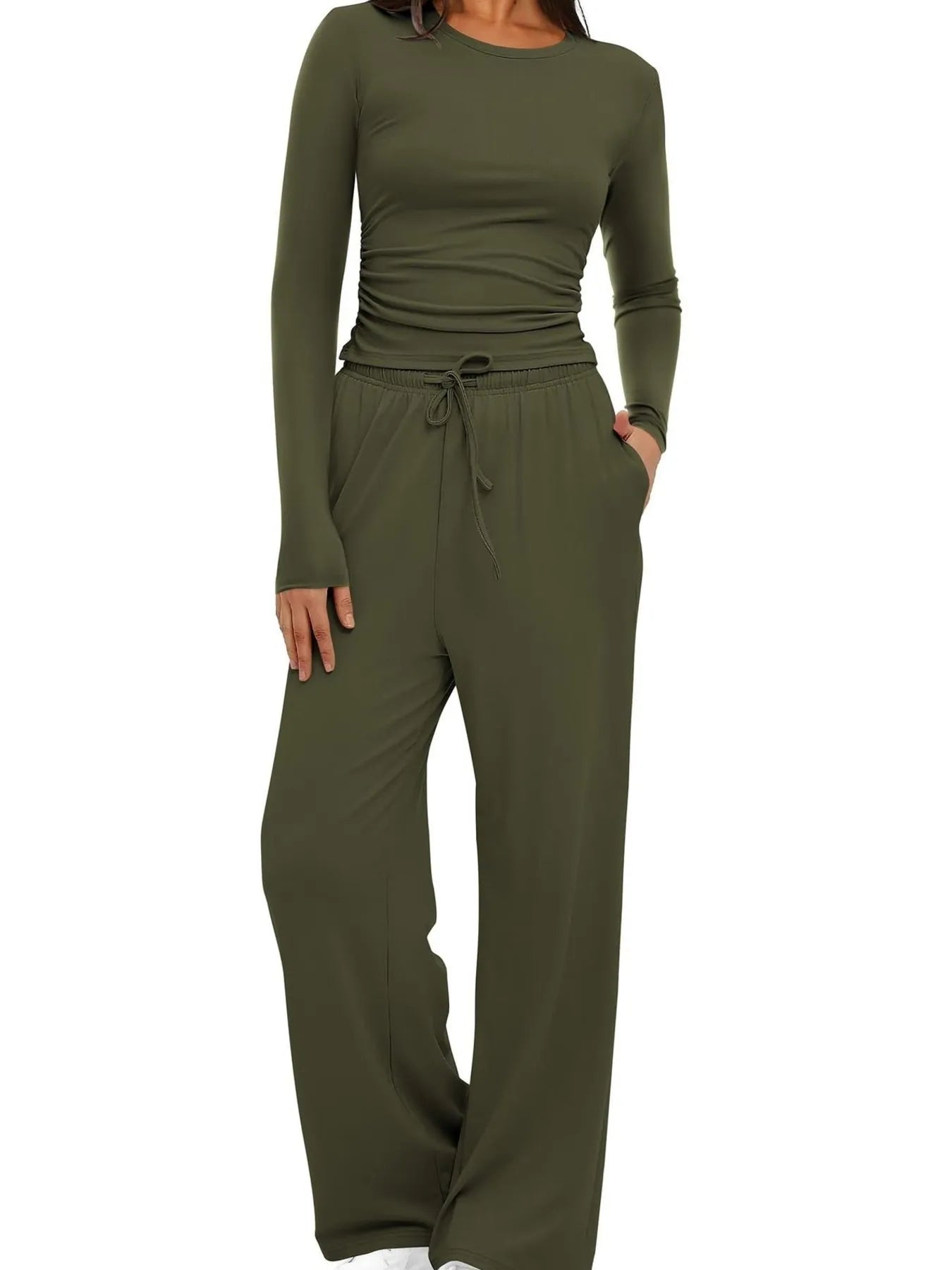 Green jumpsuit with long sleeves and wide-leg pants on a white background