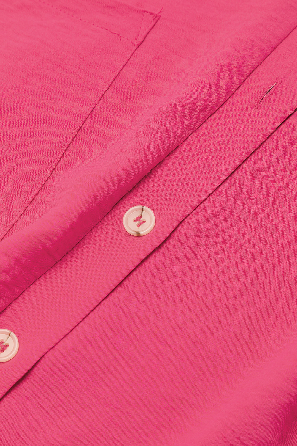Close-up of a pink shirt with buttons