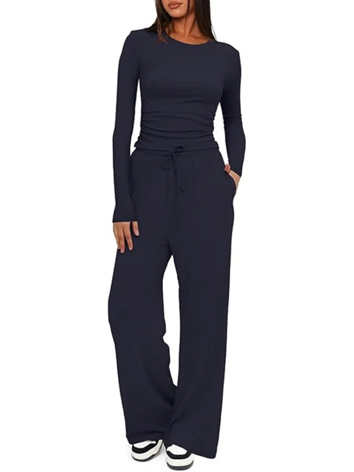 Navy blue jumpsuit worn by a model on a white background