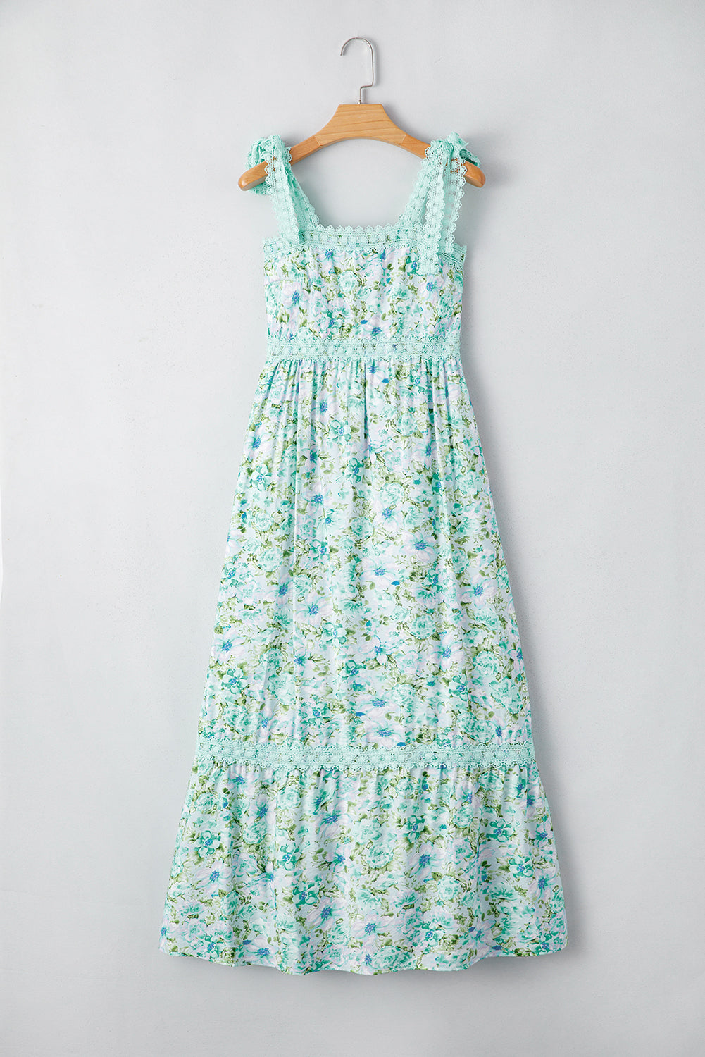 Floral dress on a hanger against a gray background
