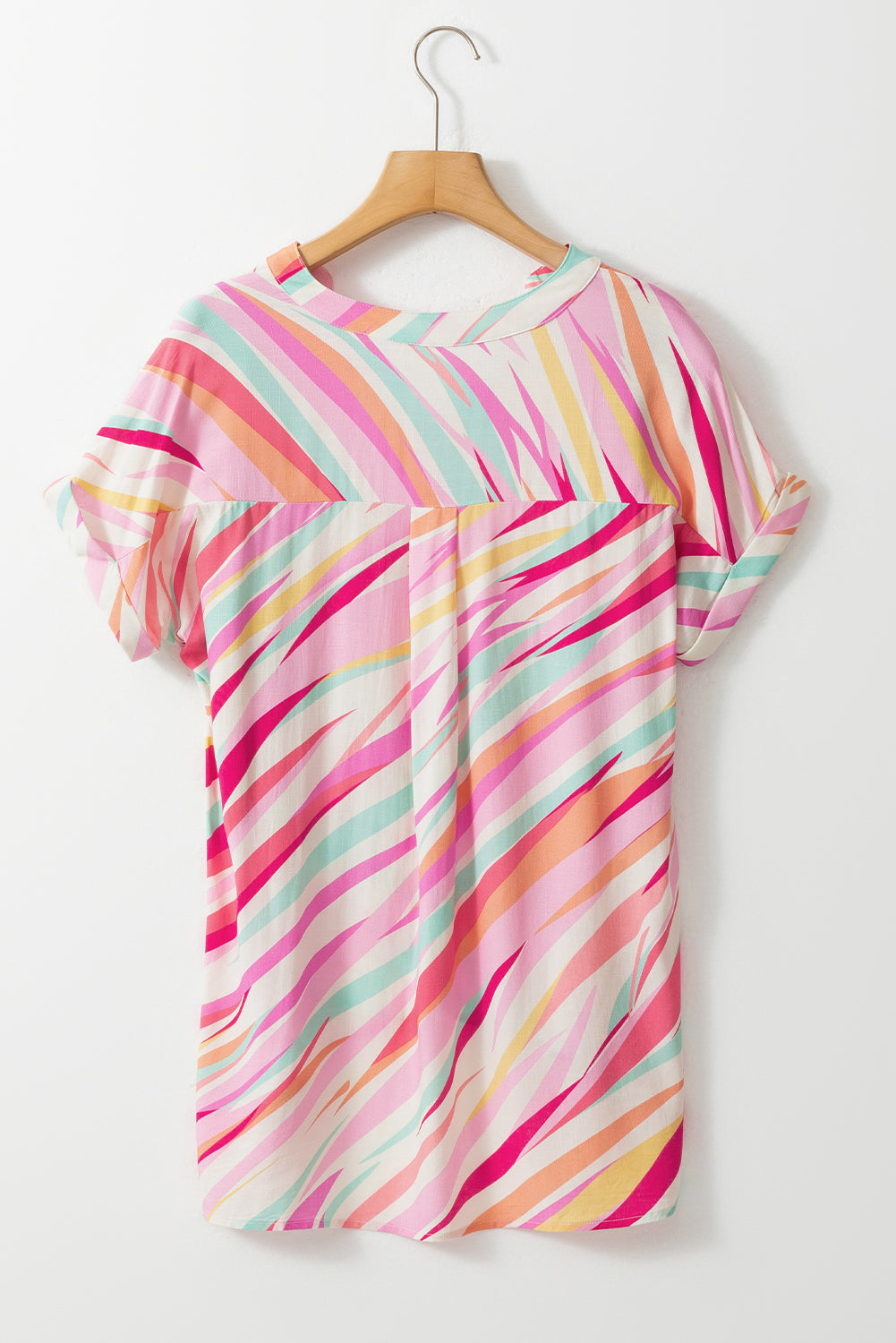 Colorful striped dress on a hanger against a white background
