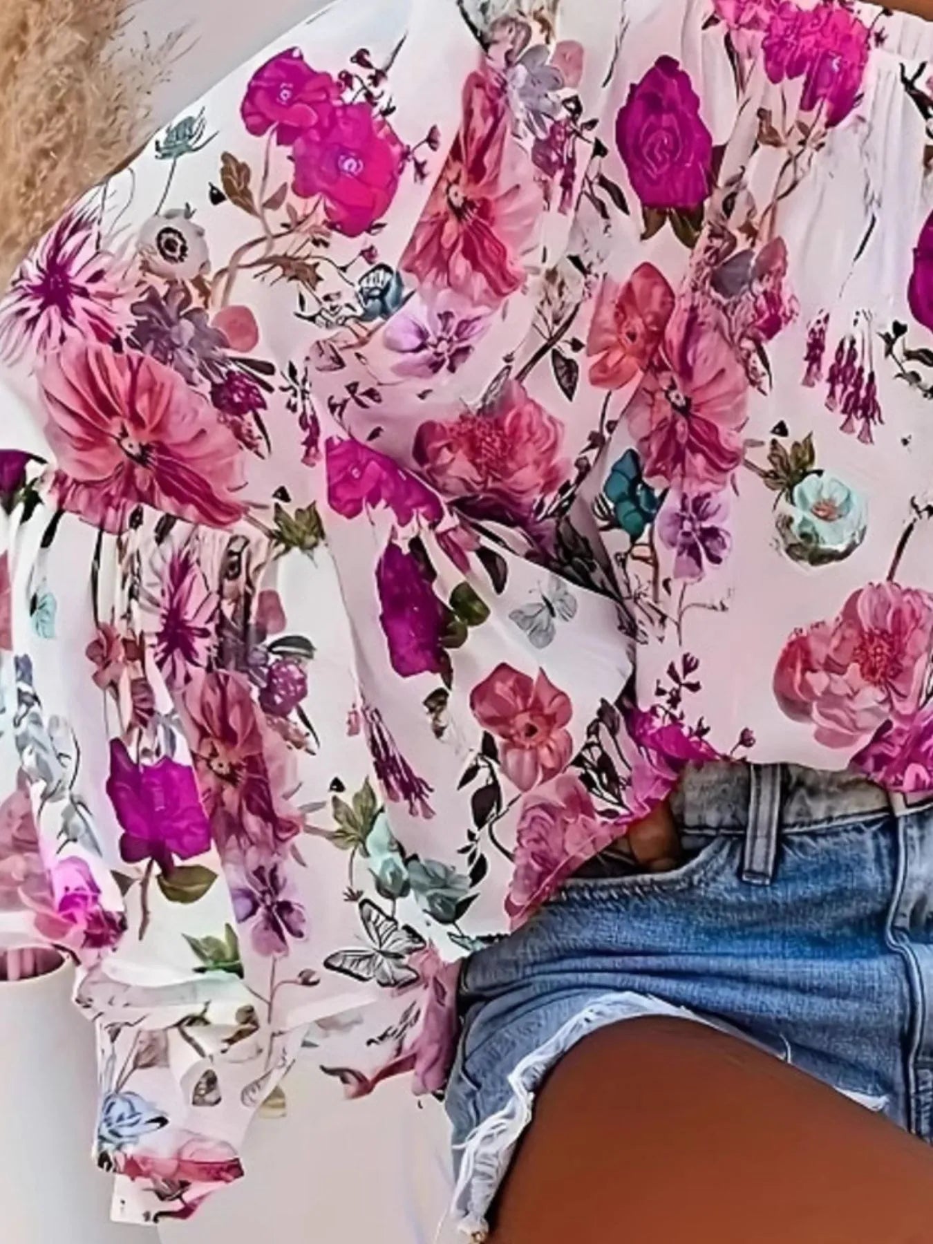 Floral-patterned shirt with pink flowers and green leaves on a white background