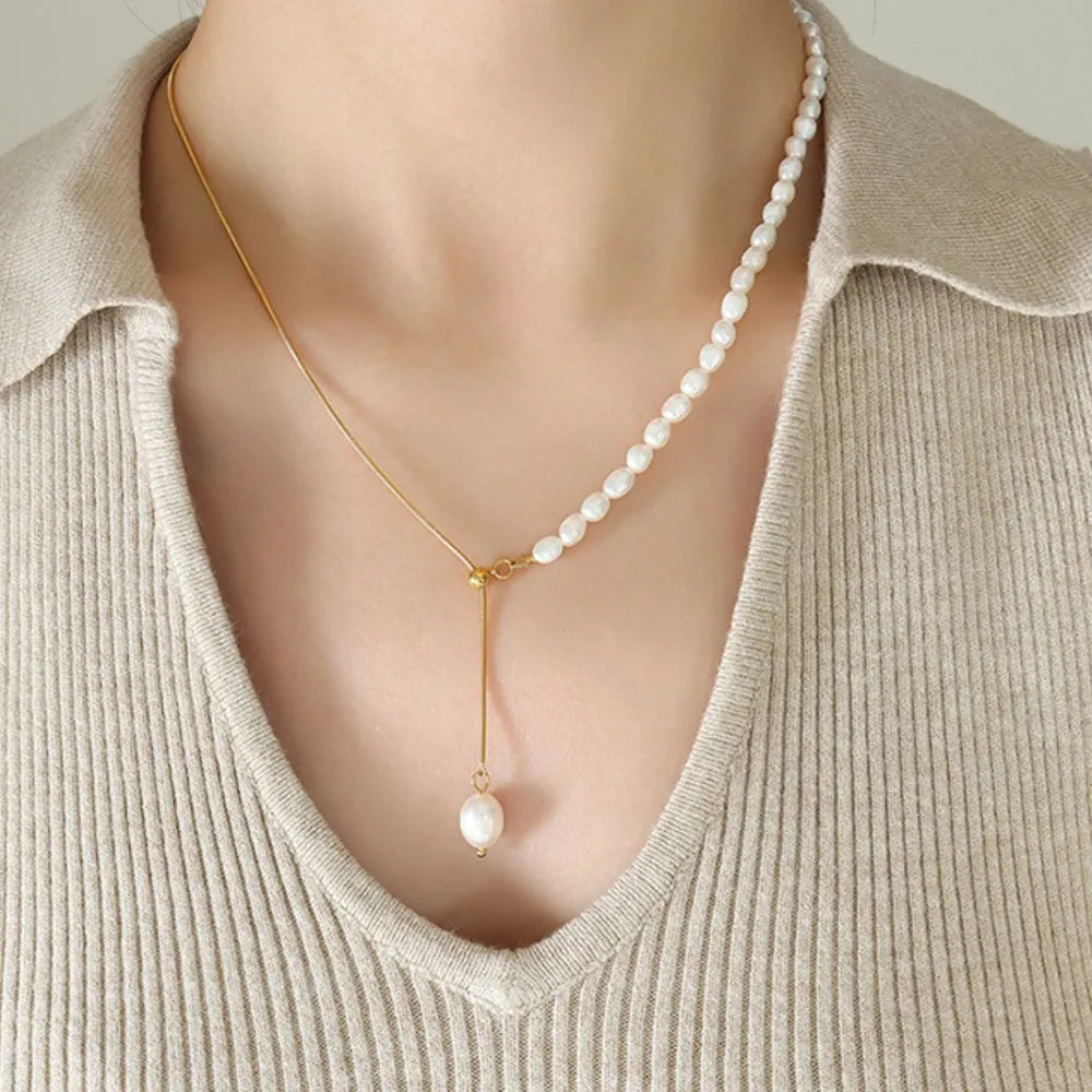 woman wearing a gold and pearl necklace