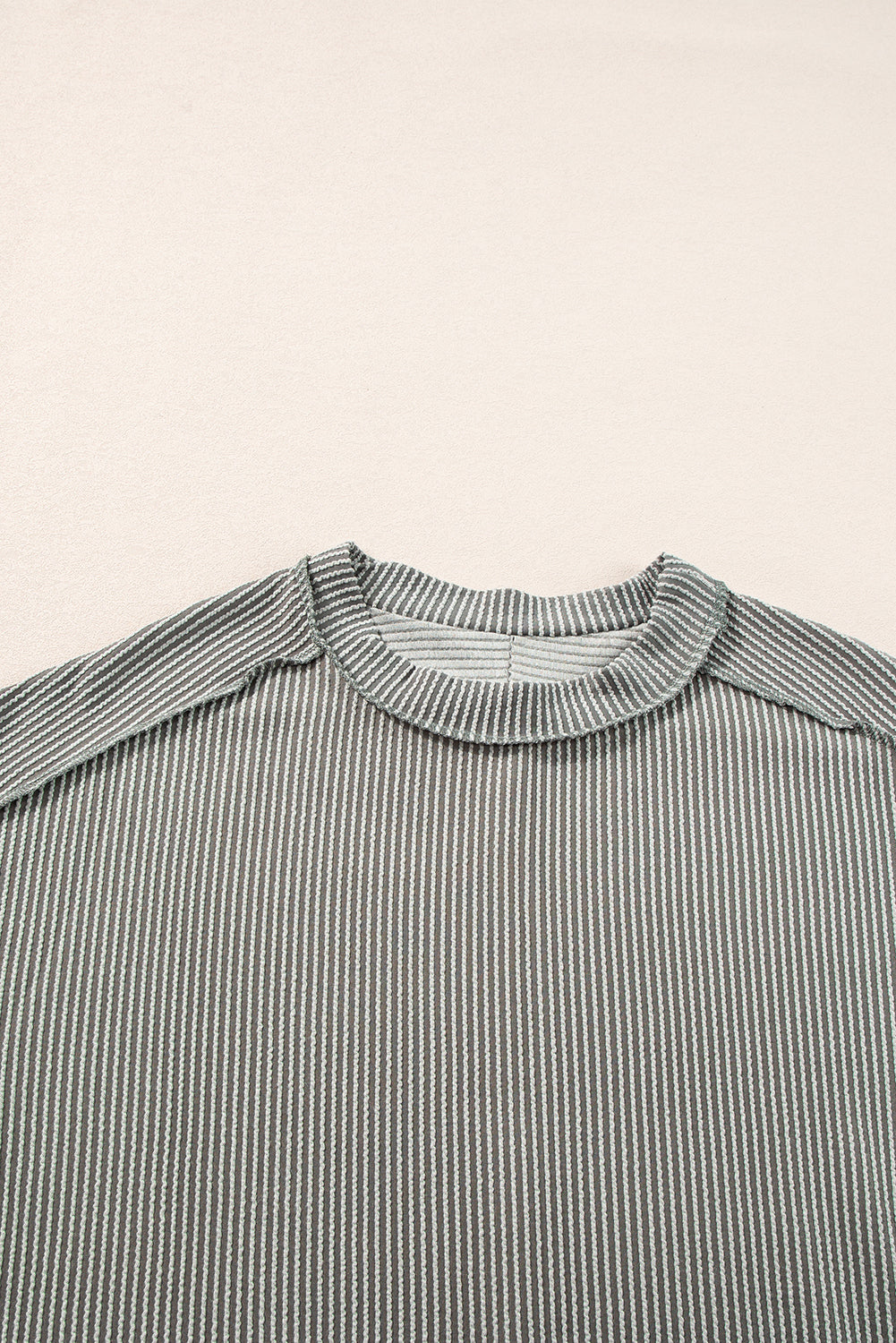 Close-up of a striped shirt with a high collar on a beige background