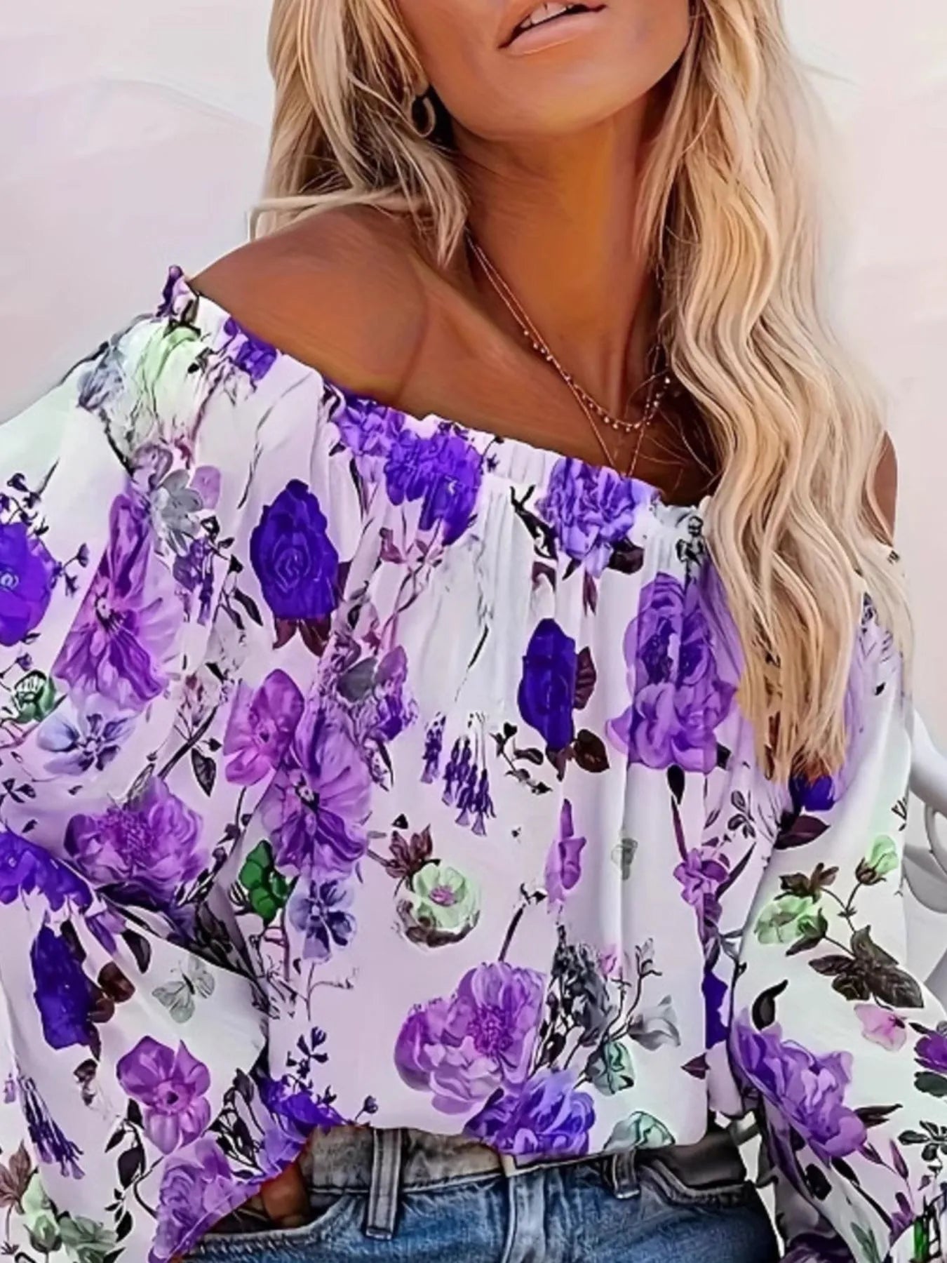 Woman wearing a floral off-shoulder top with purple flowers on a white background