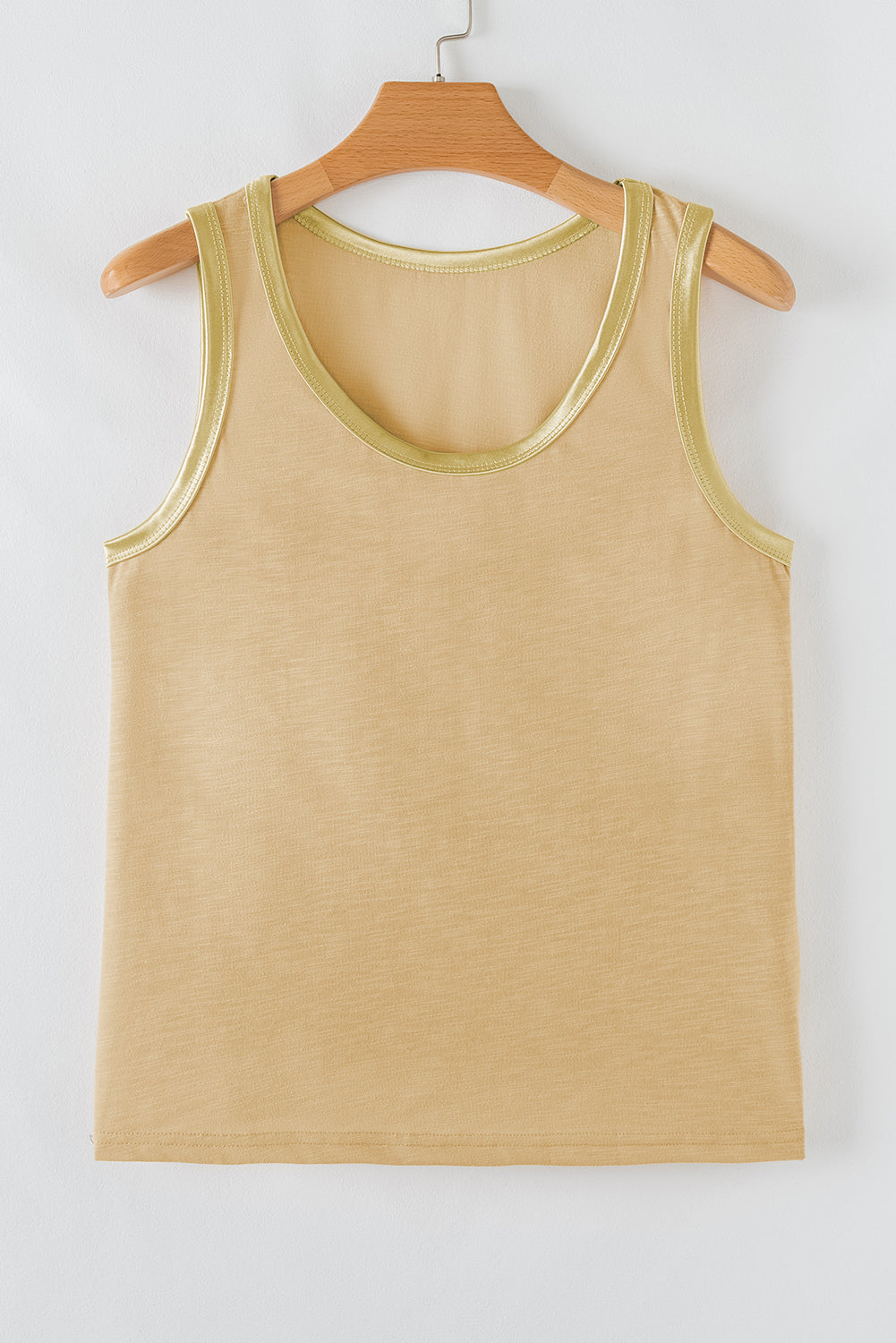 Beige tank top on a wooden hanger against a white background