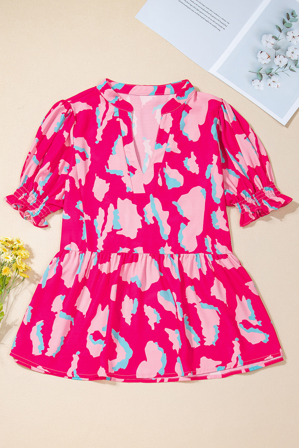 Pink dress with abstract pattern on a beige background