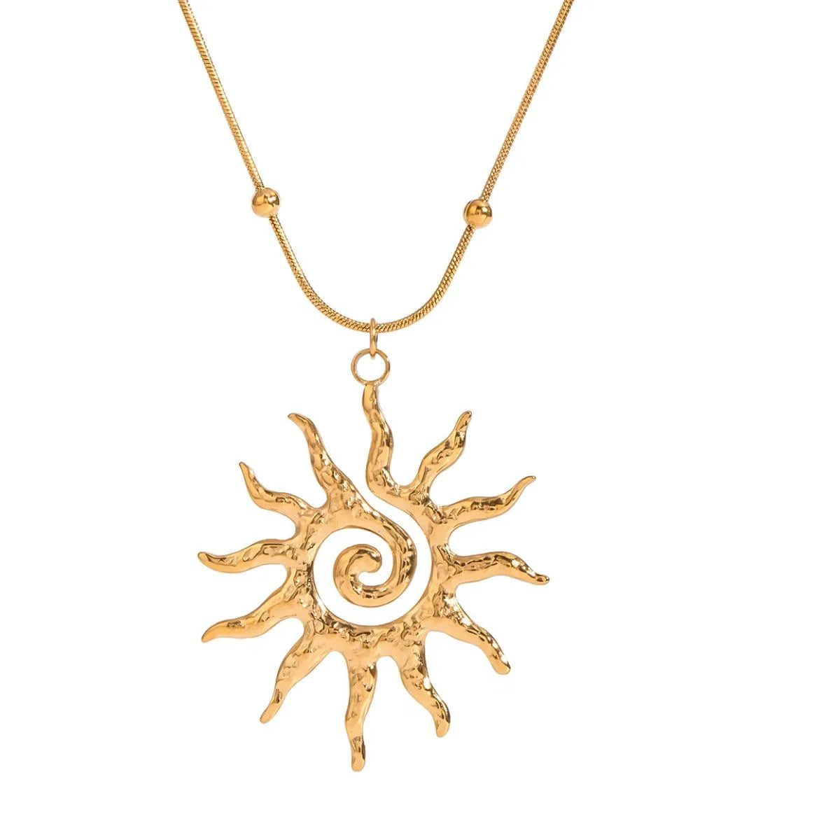 Gold sun-shaped pendant on a chain against a white background