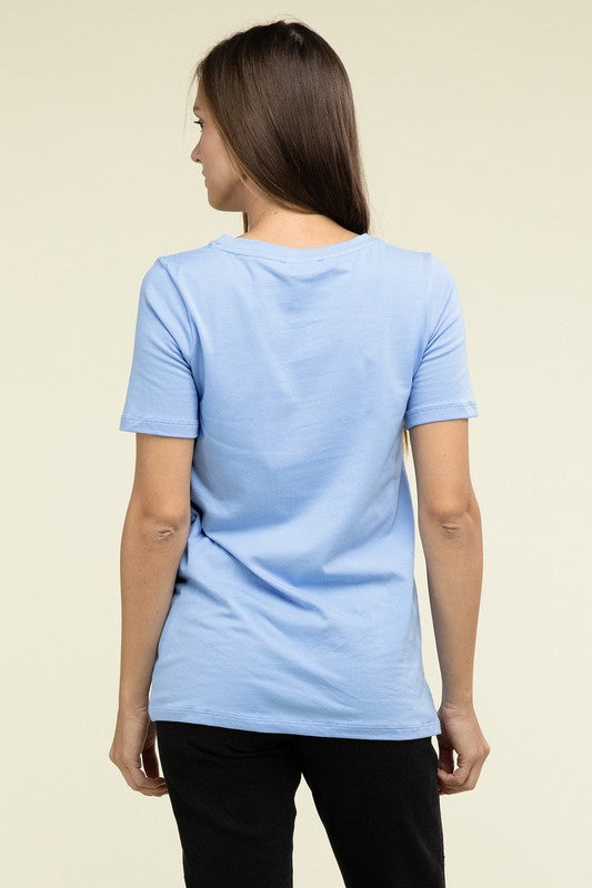 Woman wearing a light blue t-shirt on a beige background