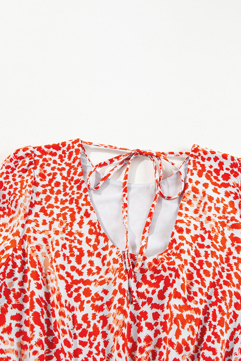 Red and white patterned top on a light gray background