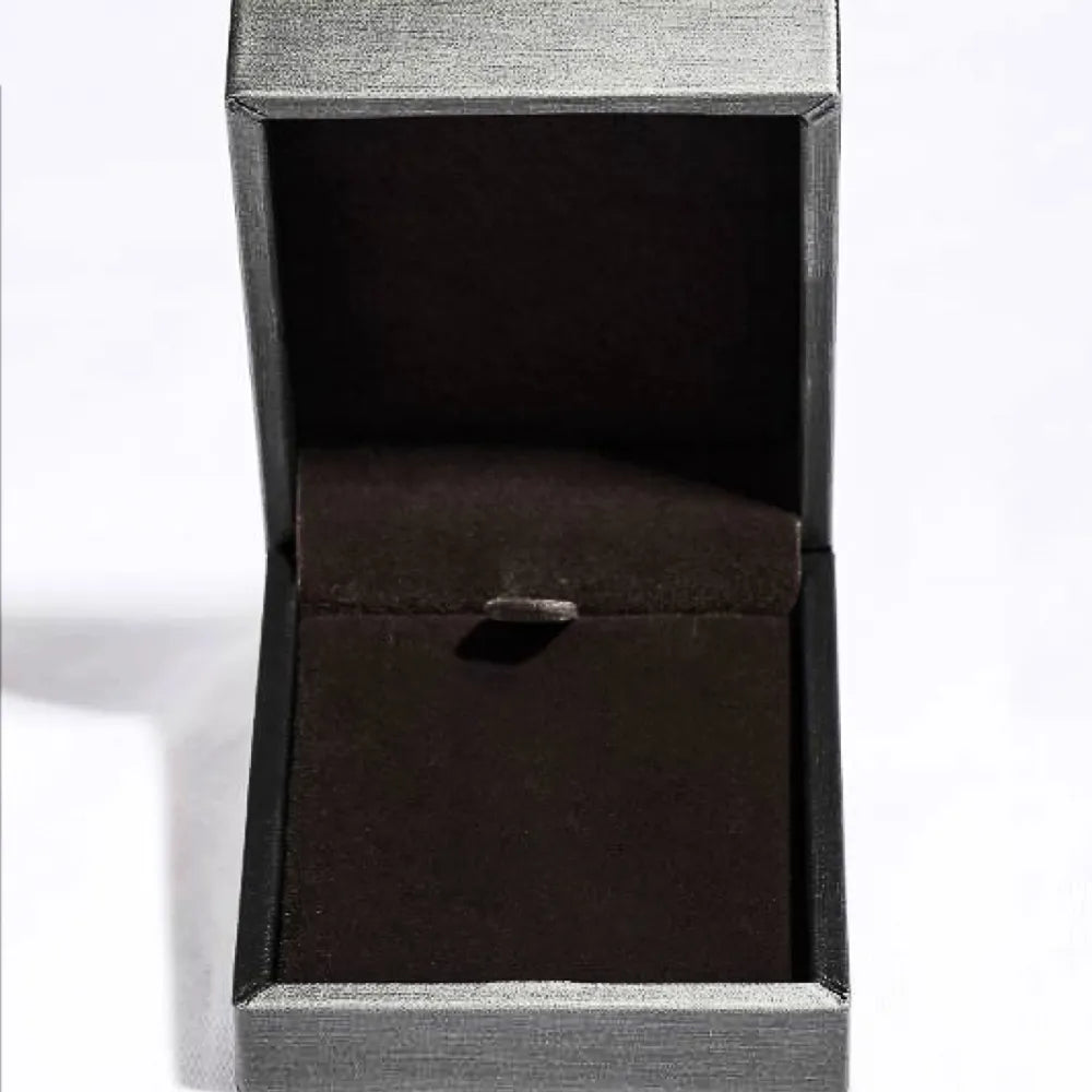 Black jewelry box with a textured surface on a white background