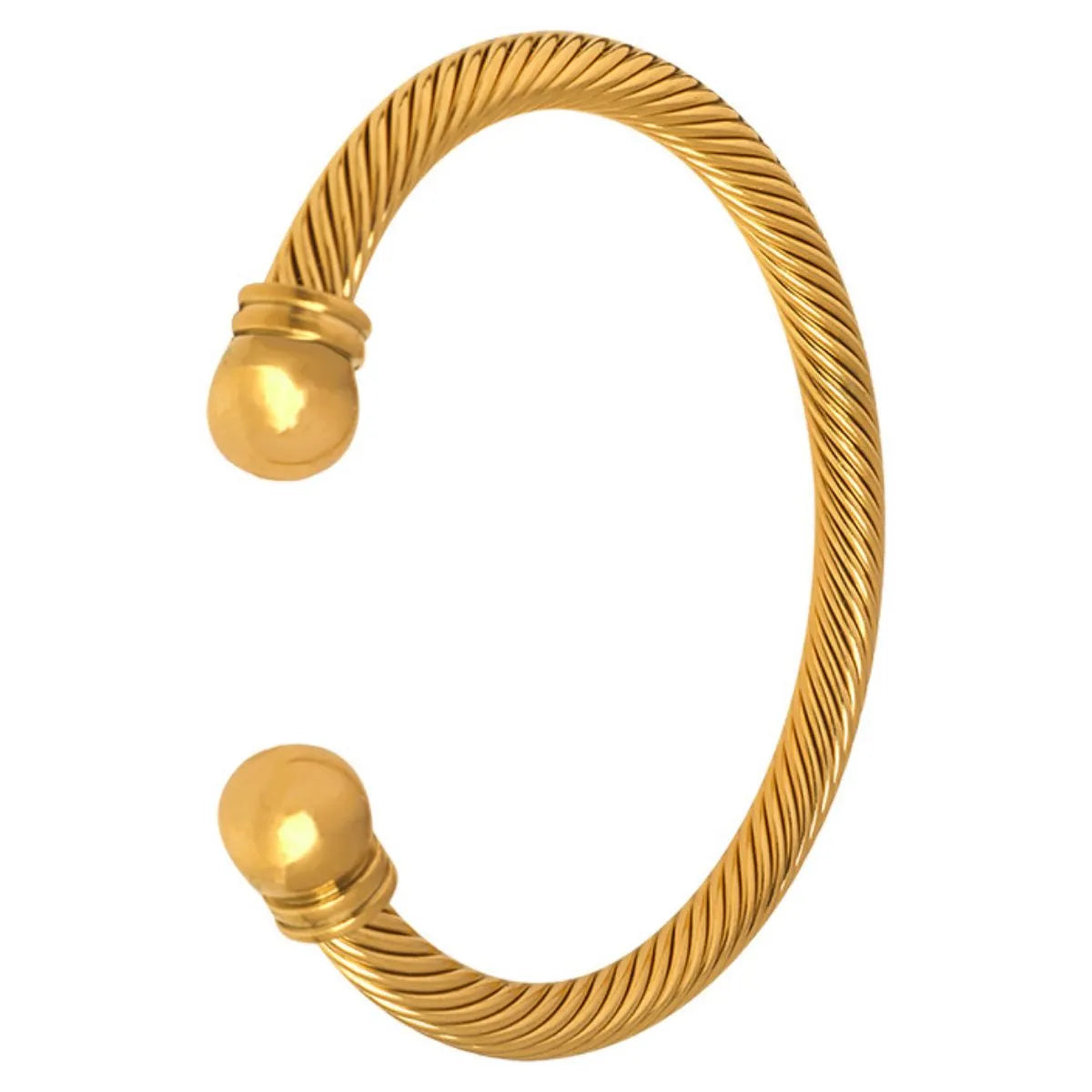 Gold bangle with a textured design on a white background