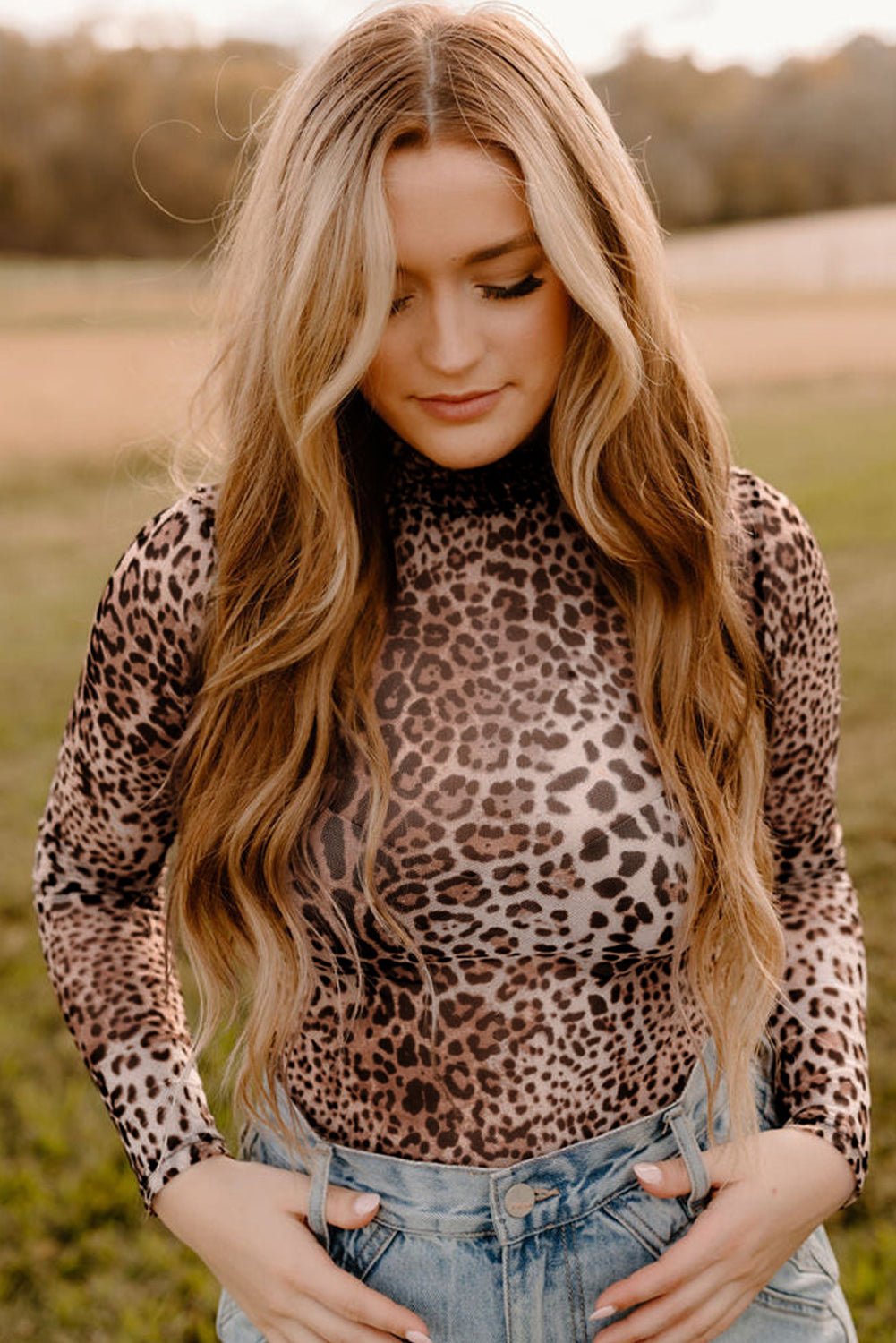 Woman wearing a leopard print top in an outdoor setting