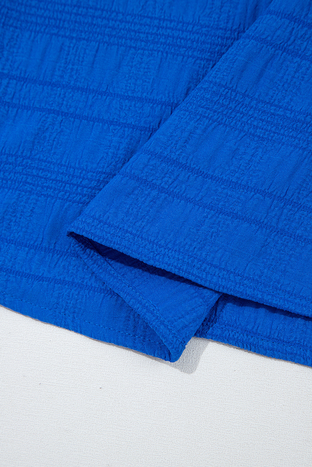 Close-up of blue textured fabric on a white background