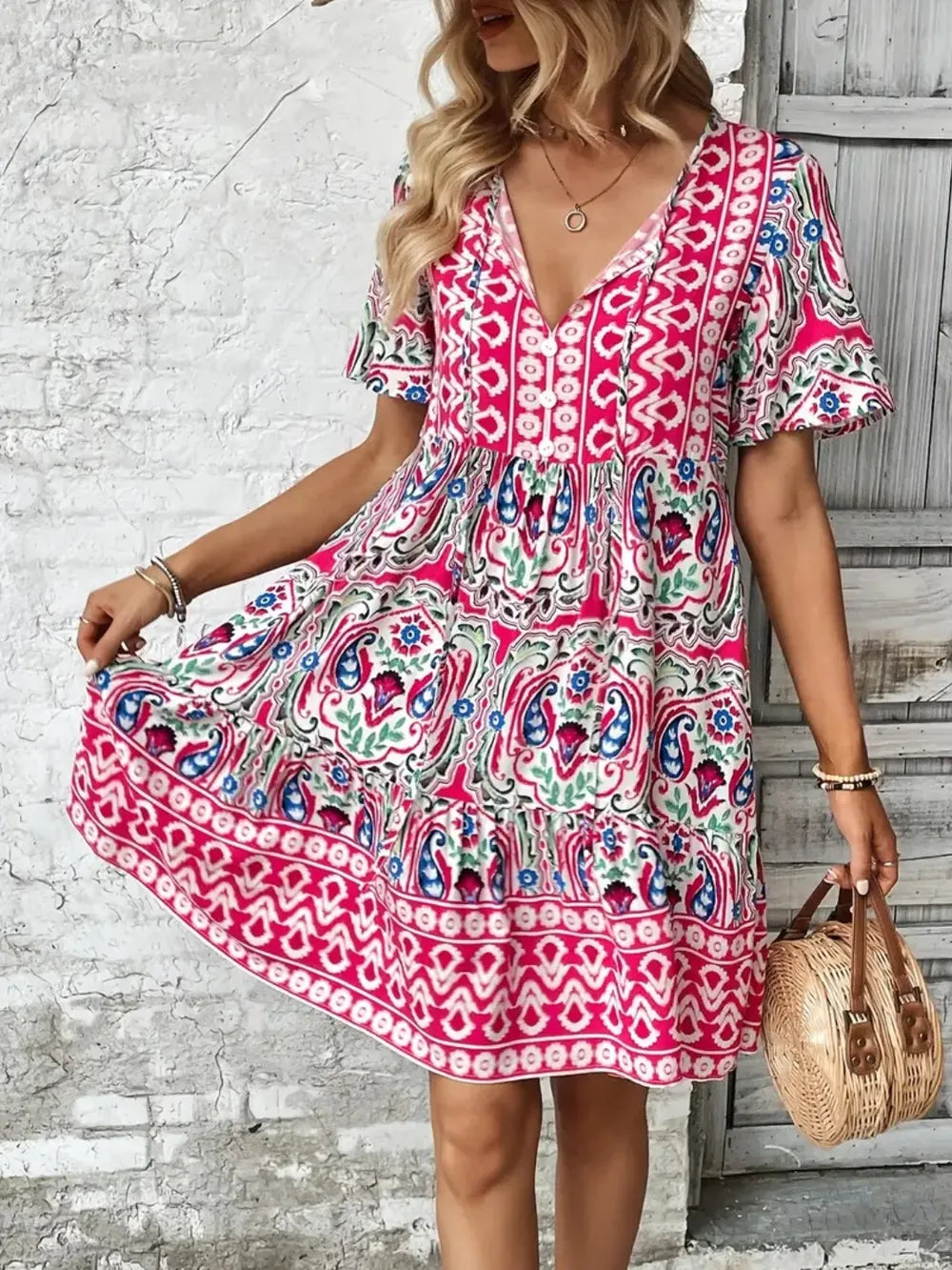 Woman wearing a colorful patterned dress with a wooden background