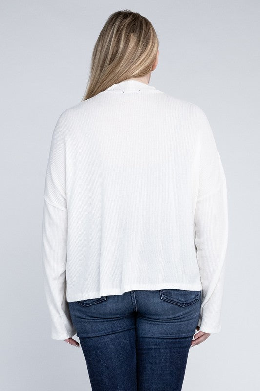Person wearing a white blouse and blue jeans on a plain background