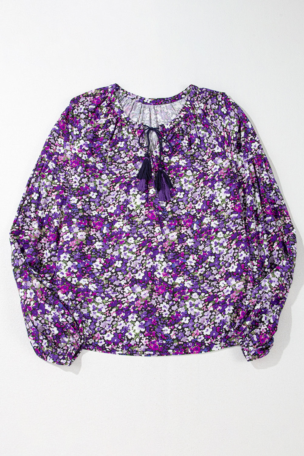Floral blouse with purple and white pattern on a white background