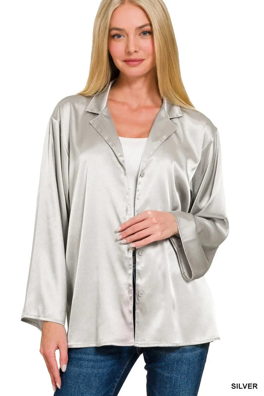 Woman wearing a silver satin jacket on a white background