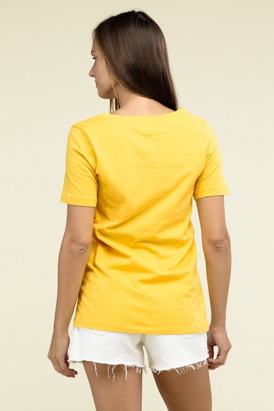 Woman wearing a yellow t-shirt and white shorts on a beige background