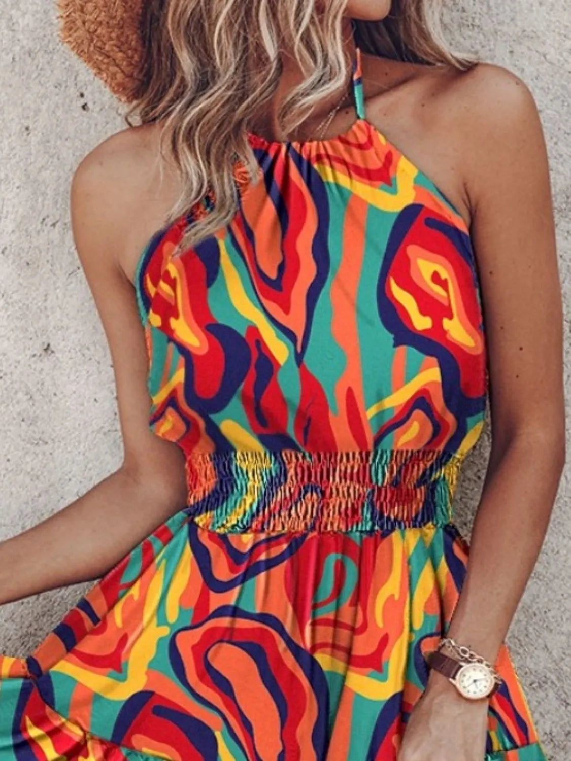 Colorful patterned dress worn by a person against a neutral background